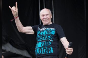 John Hetlinger on stage with a microphone