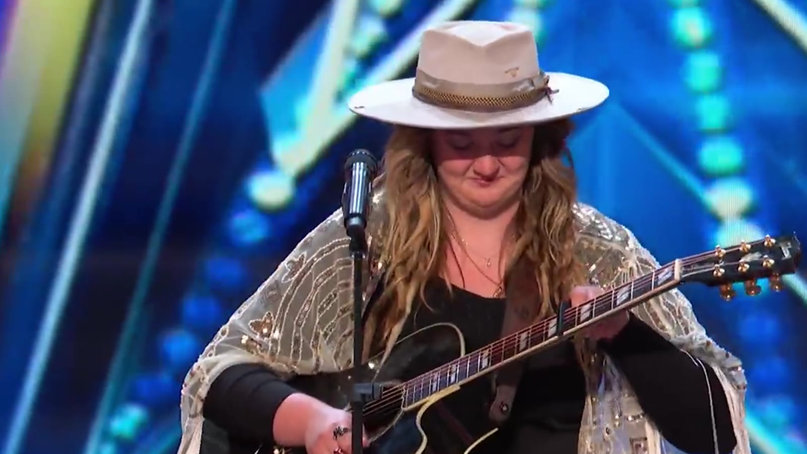 Dani Kerr singing with her guitar on America's Got Talent