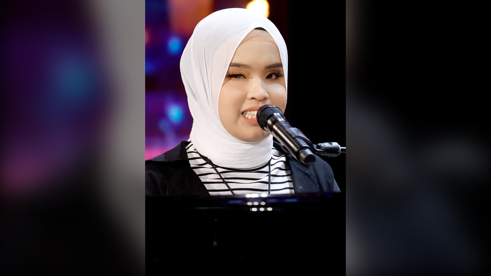Putri Ariani singing at the piano